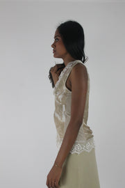 alternate side view of small cream satin-effect sleeveless top with white lace trim