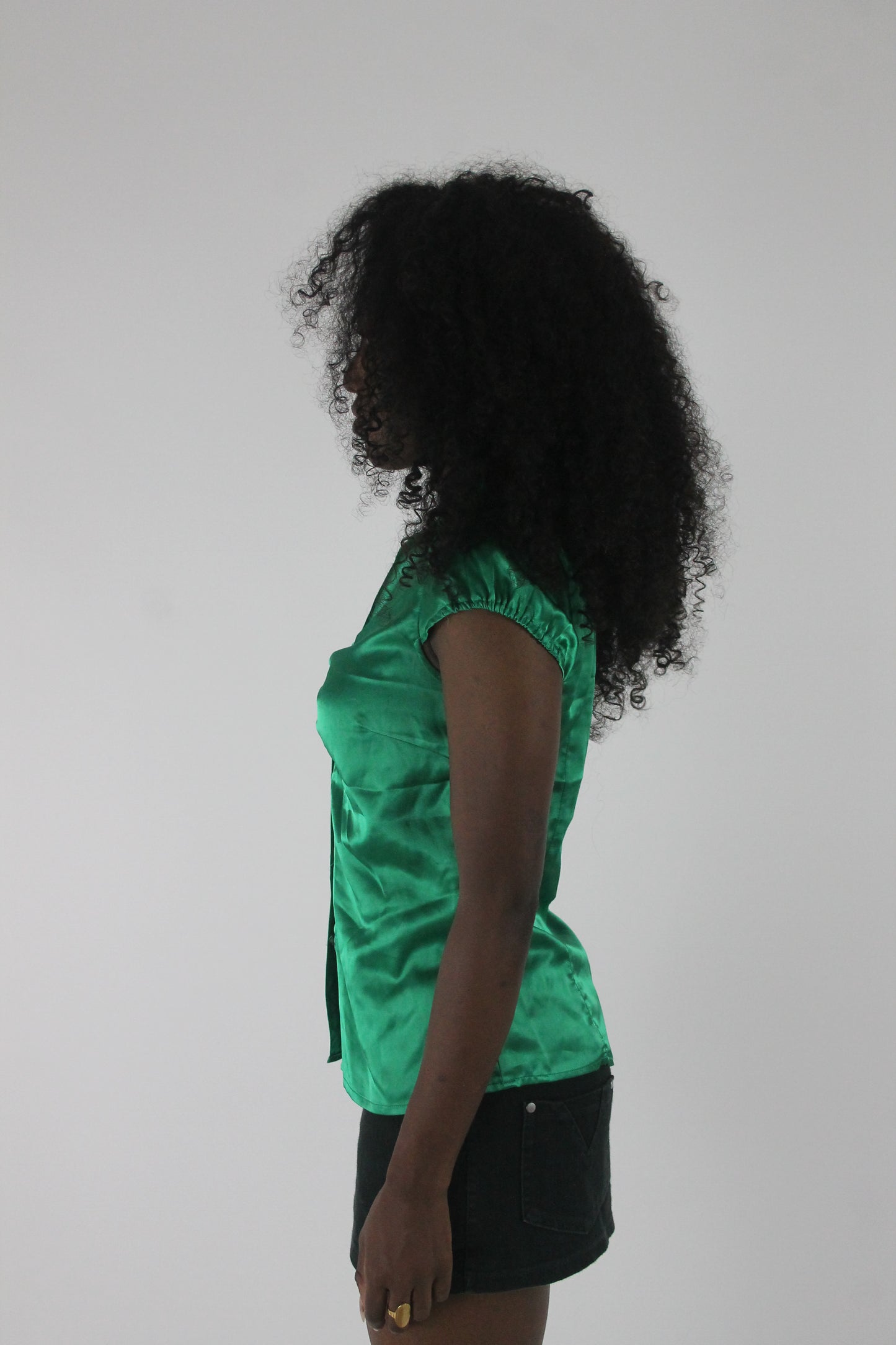 side view of emerald green satin-effect fitted short-sleeve shirt
