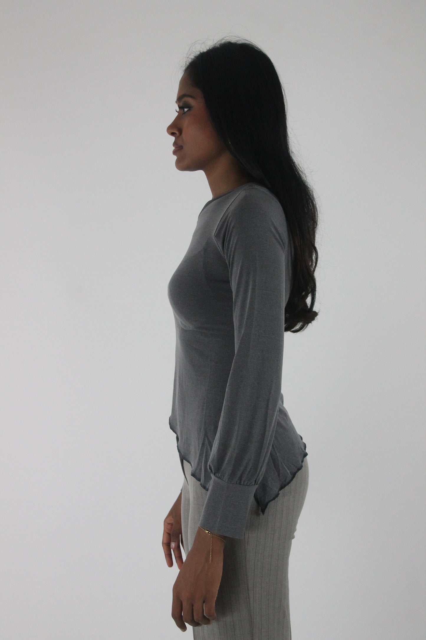 alternate-side view of grey asymmetric one-shoulder long-sleeve top