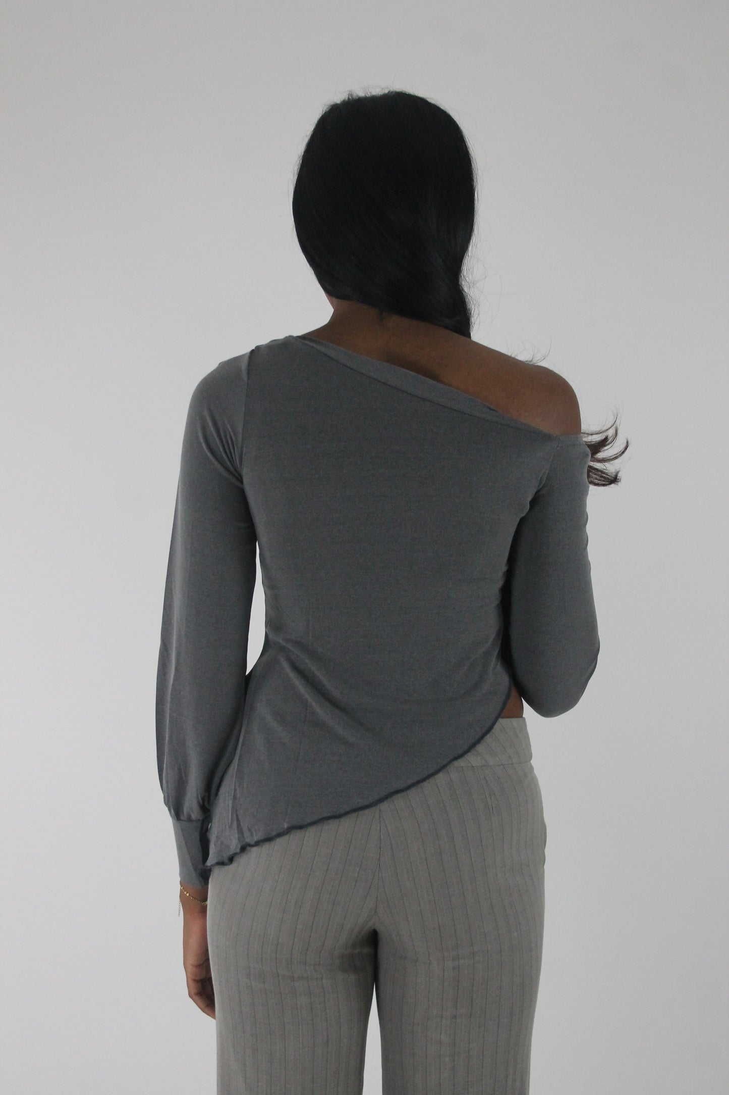 back view of grey asymmetric one-shoulder long-sleeve top