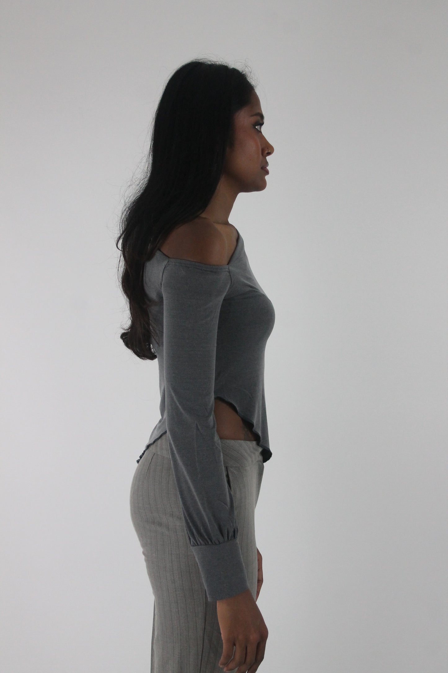 side view of grey asymmetric one-shoulder long-sleeve top