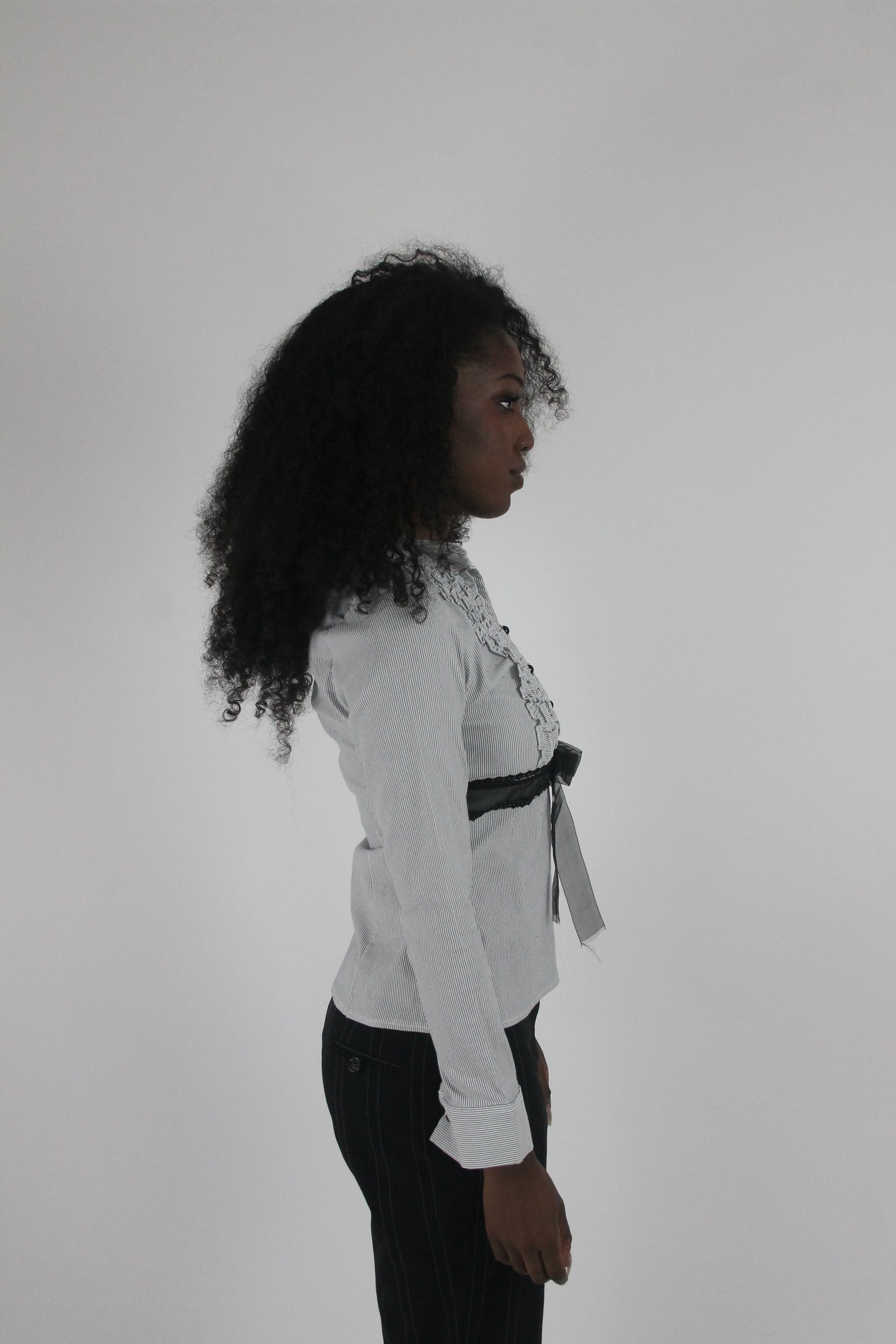 alternate-side view of white black-trim tie-front blouse