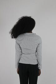 back view of white black-trim tie-front blouse