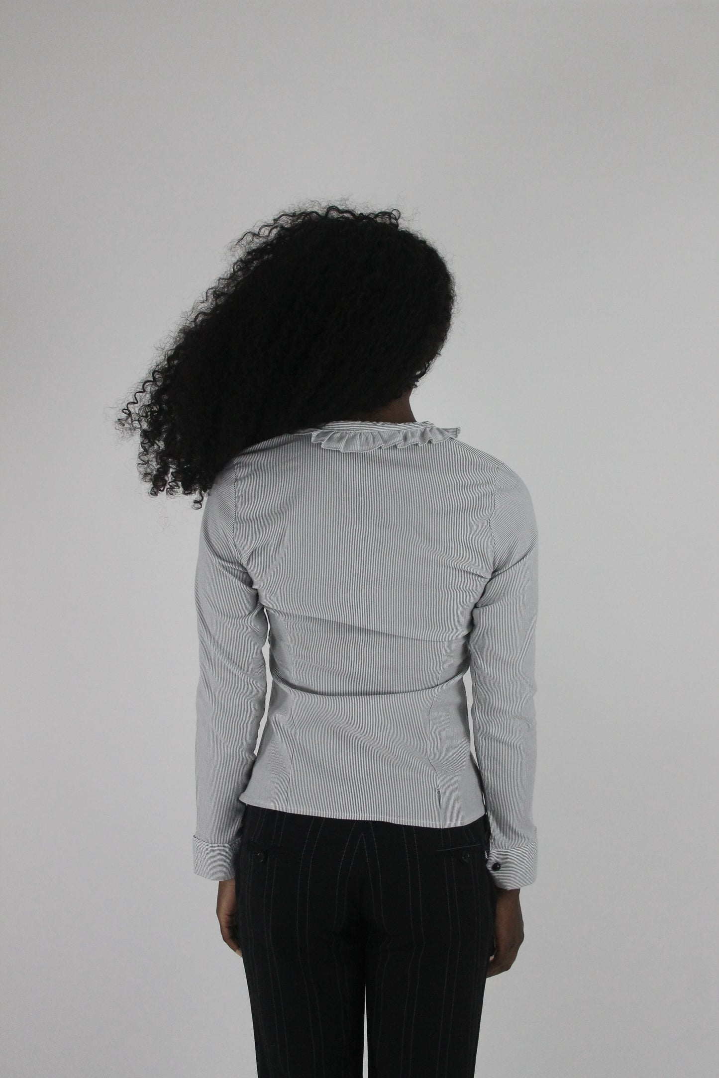 back view of white black-trim tie-front blouse