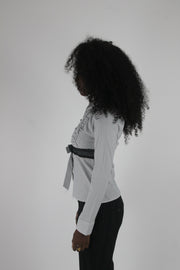 side view of white black-trim tie-front blouse