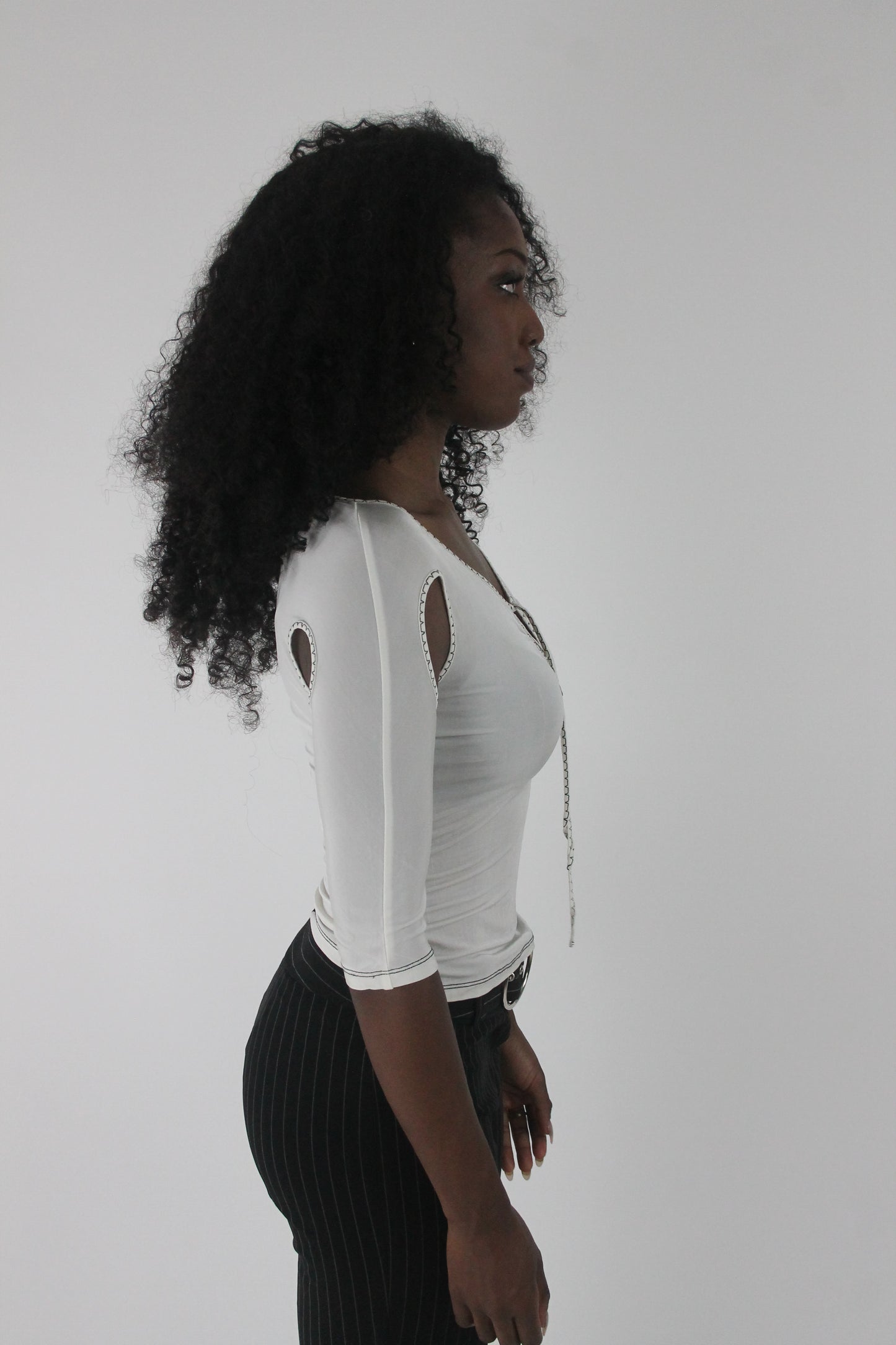 alternate-side view of white cold-shoulder tie-front top