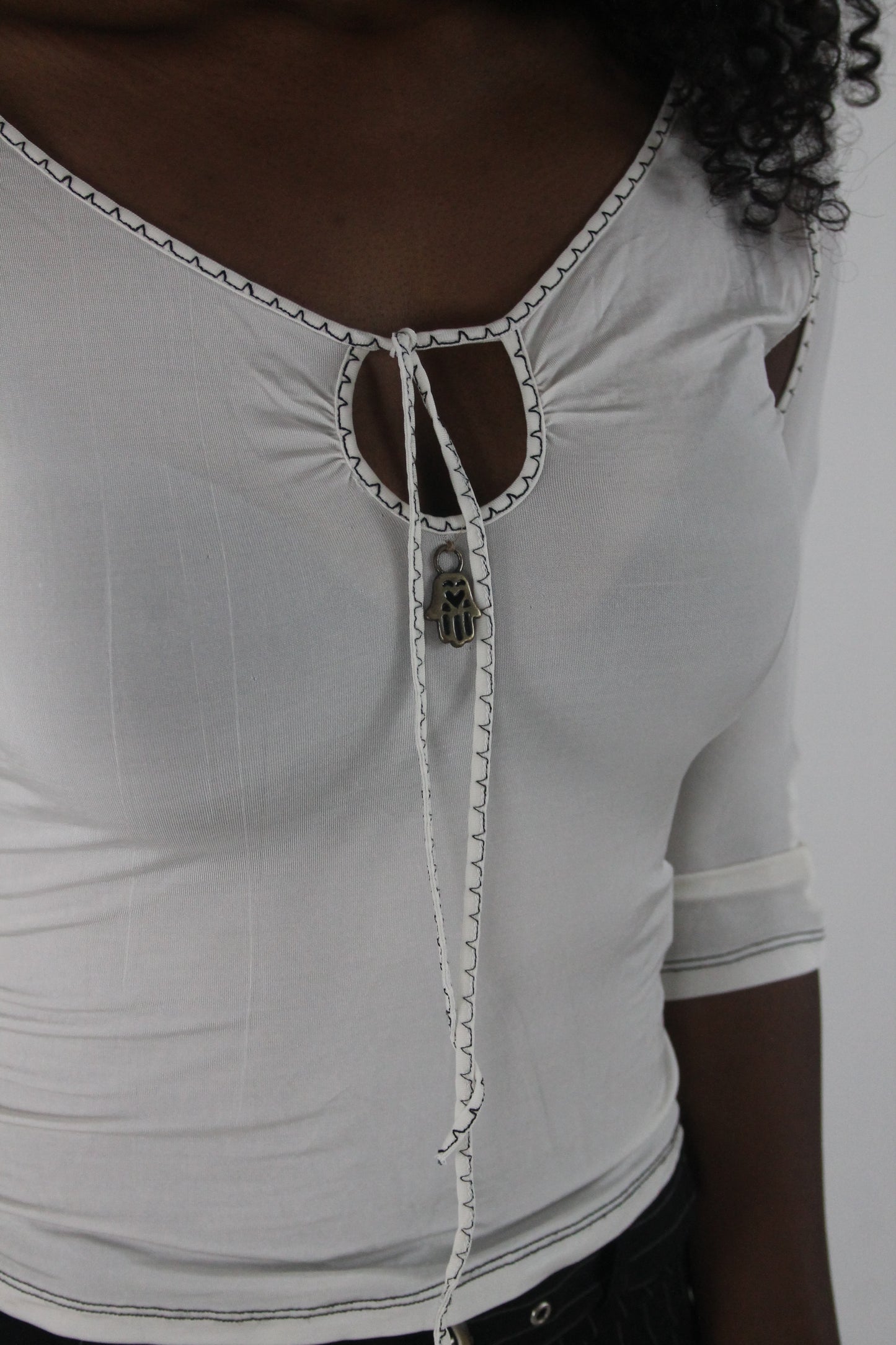 detail view of white cold-shoulder tie-front top