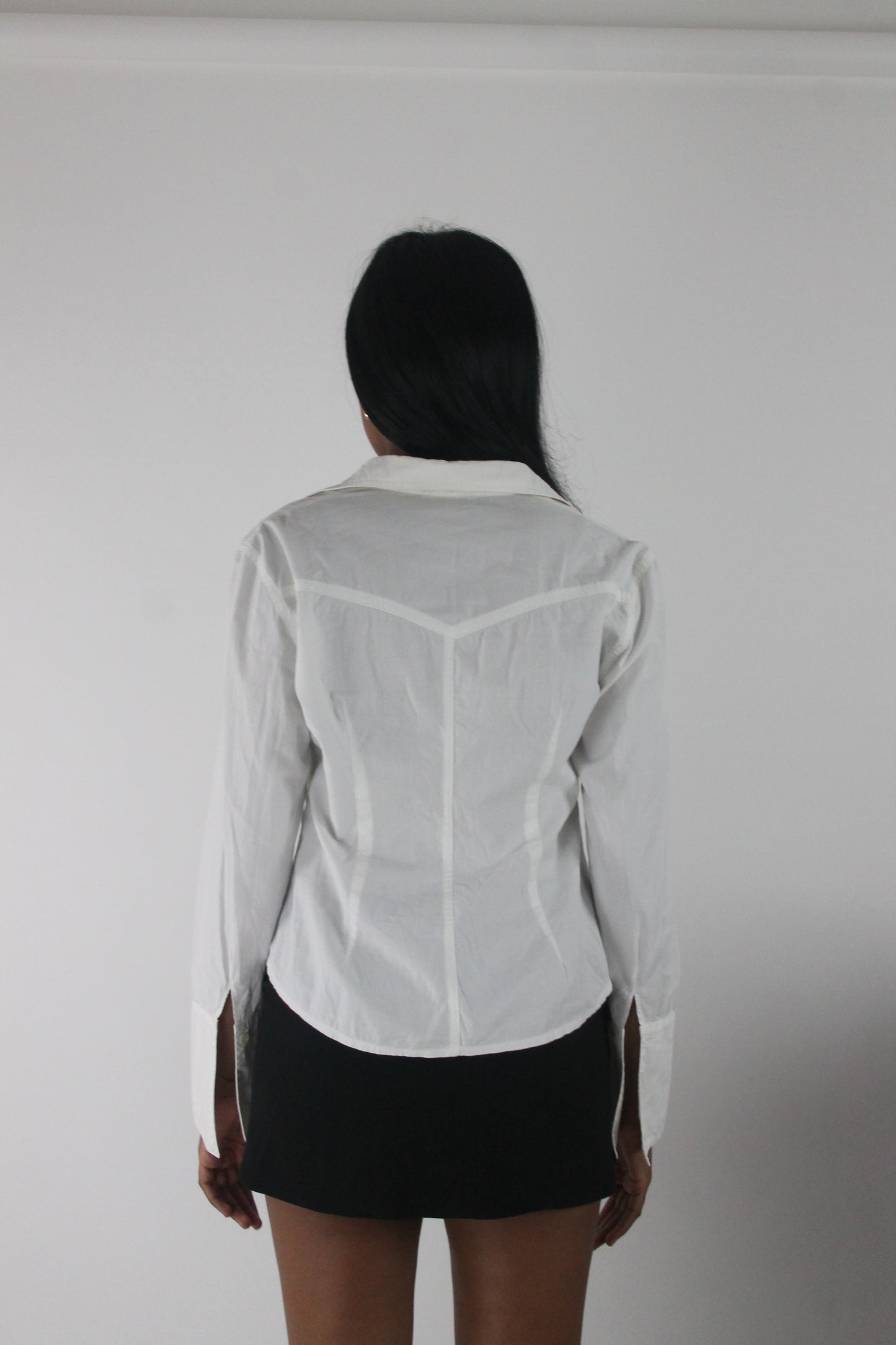 back view of white fitted long-sleeve button-up shirt
