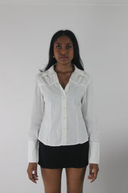 side view of white fitted long-sleeve button-up shirt