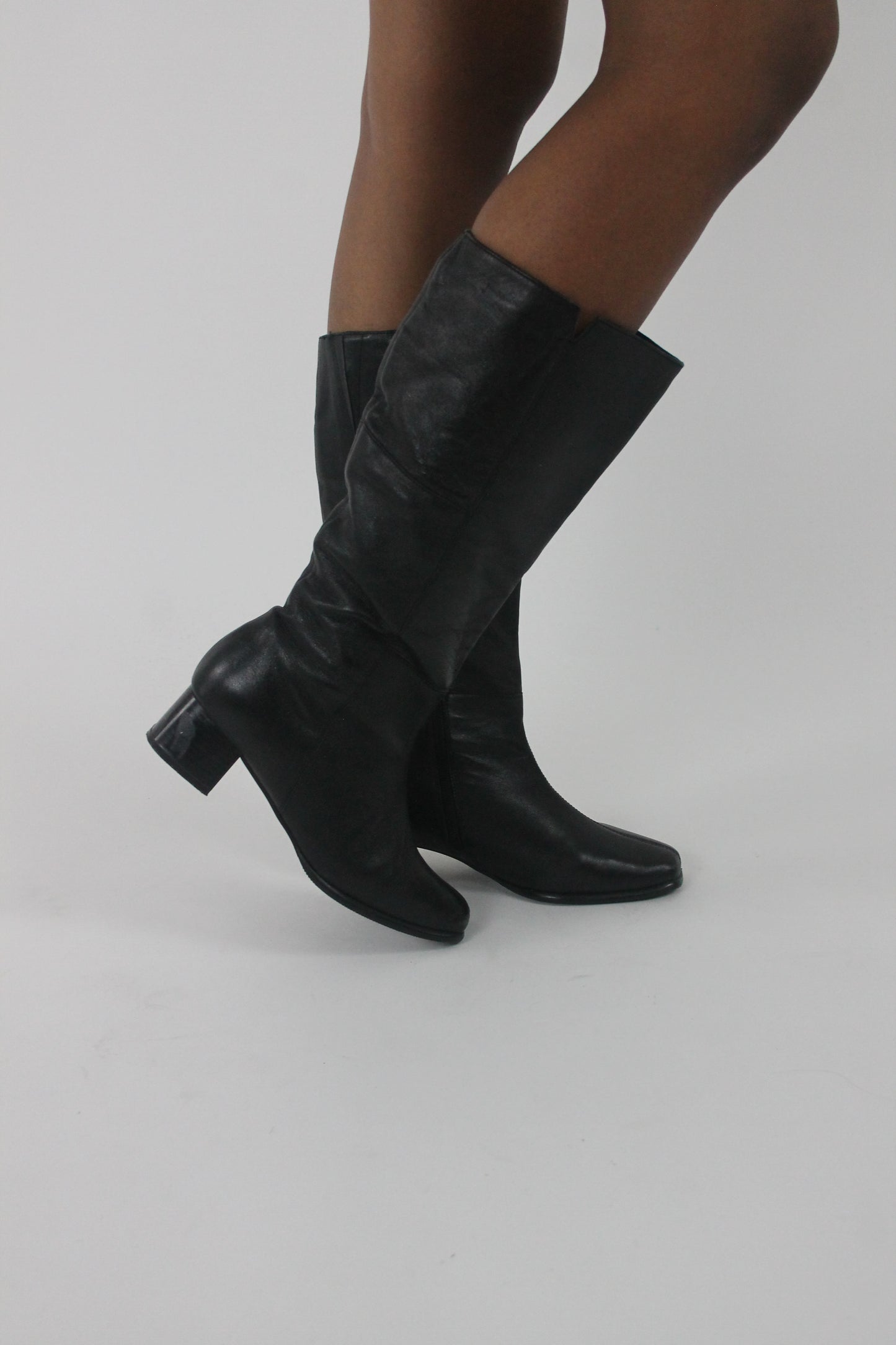 alternate-side view of black knee-high block-heel boots