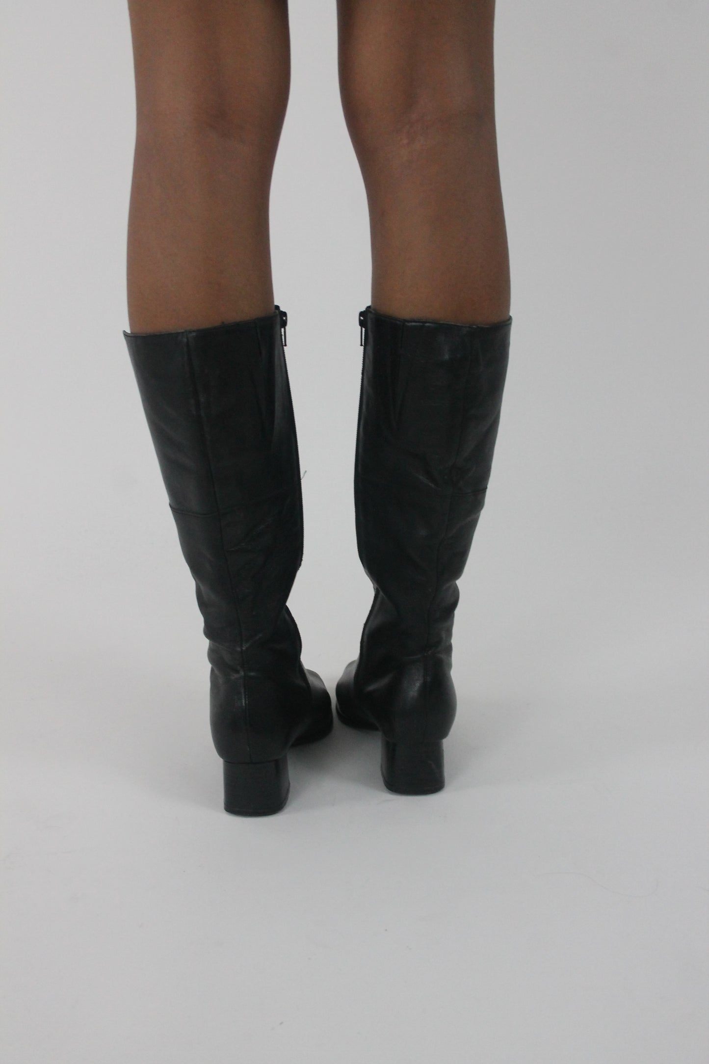back view of black knee-high block-heel boots