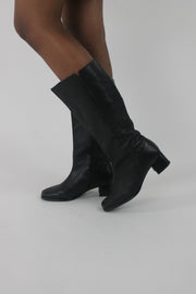 detail view of black knee-high block-heel boots