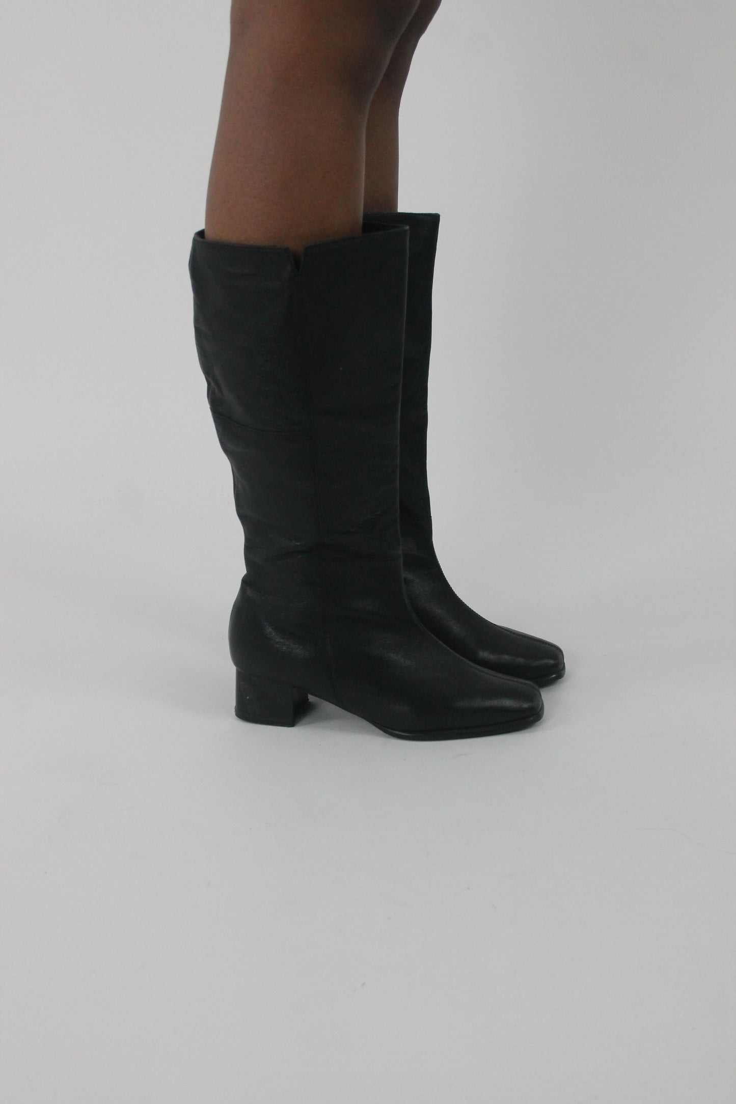 side view of black knee-high block-heel boots
