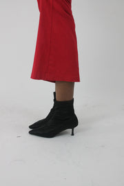 alternate-side view of black pointed-toe stiletto ankle boots