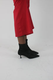 side view of black pointed-toe stiletto ankle boots