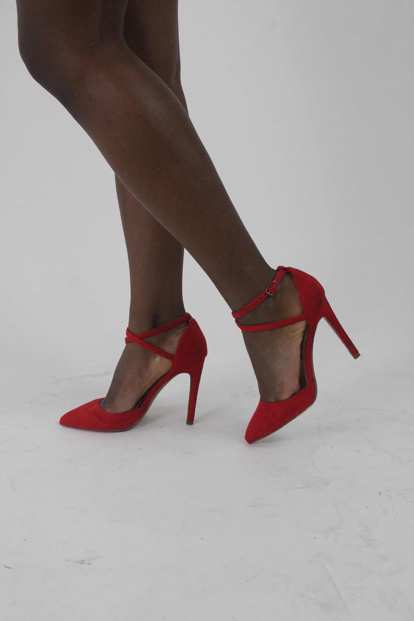 side view of red pointed-toe strappy stiletto heels