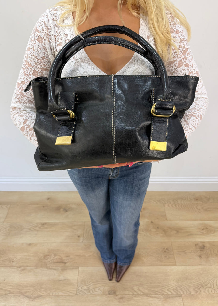 thiros black leather shoulder bag with white stitching and gold buckles 2