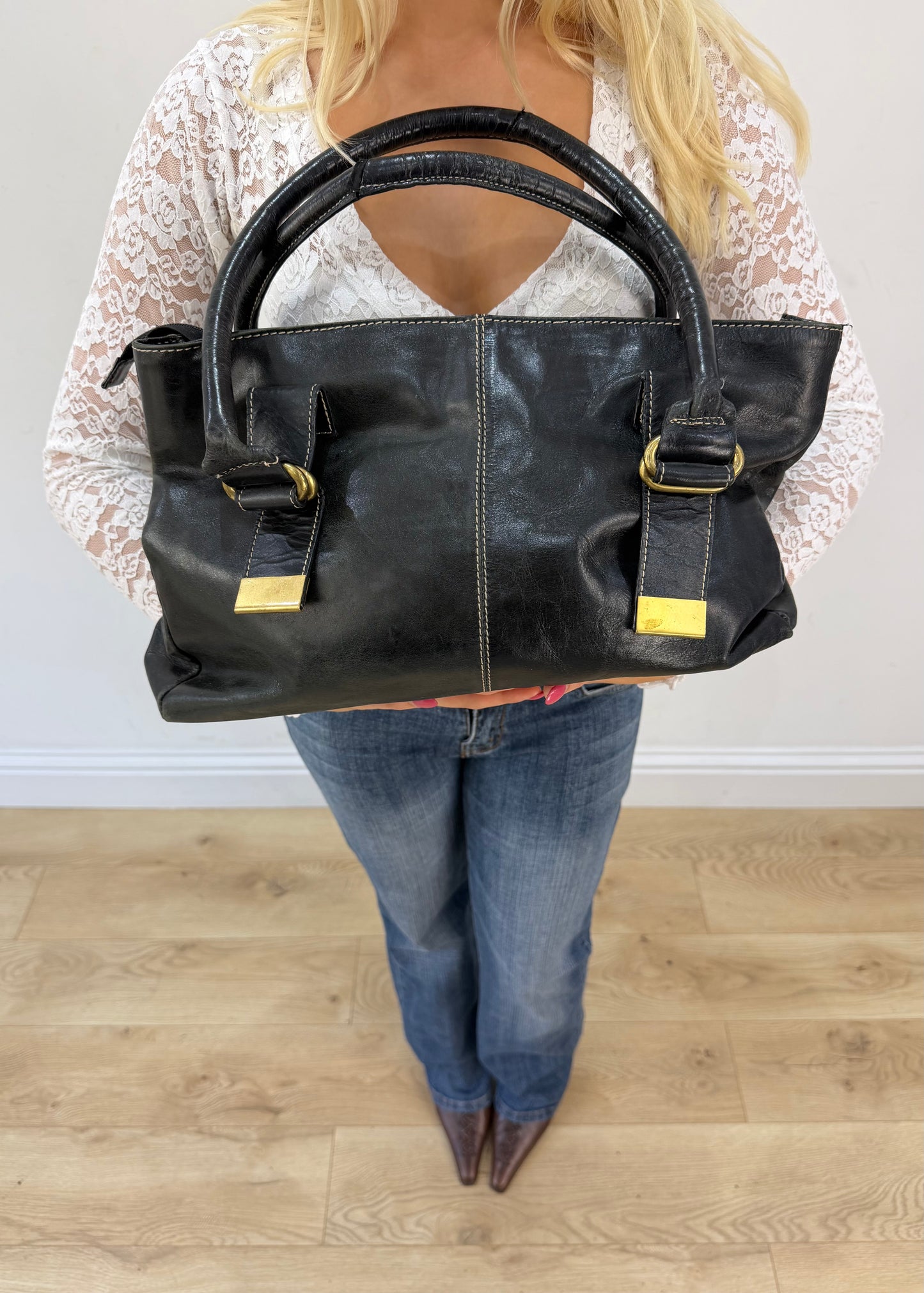 thiros black leather shoulder bag with white stitching and gold buckles 2