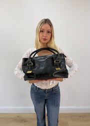 thiros black leather shoulder bag with white stitching and gold buckles 3