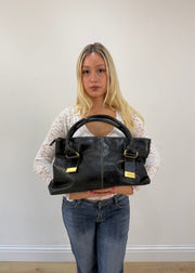 thiros black leather shoulder bag with white stitching and gold buckles 5
