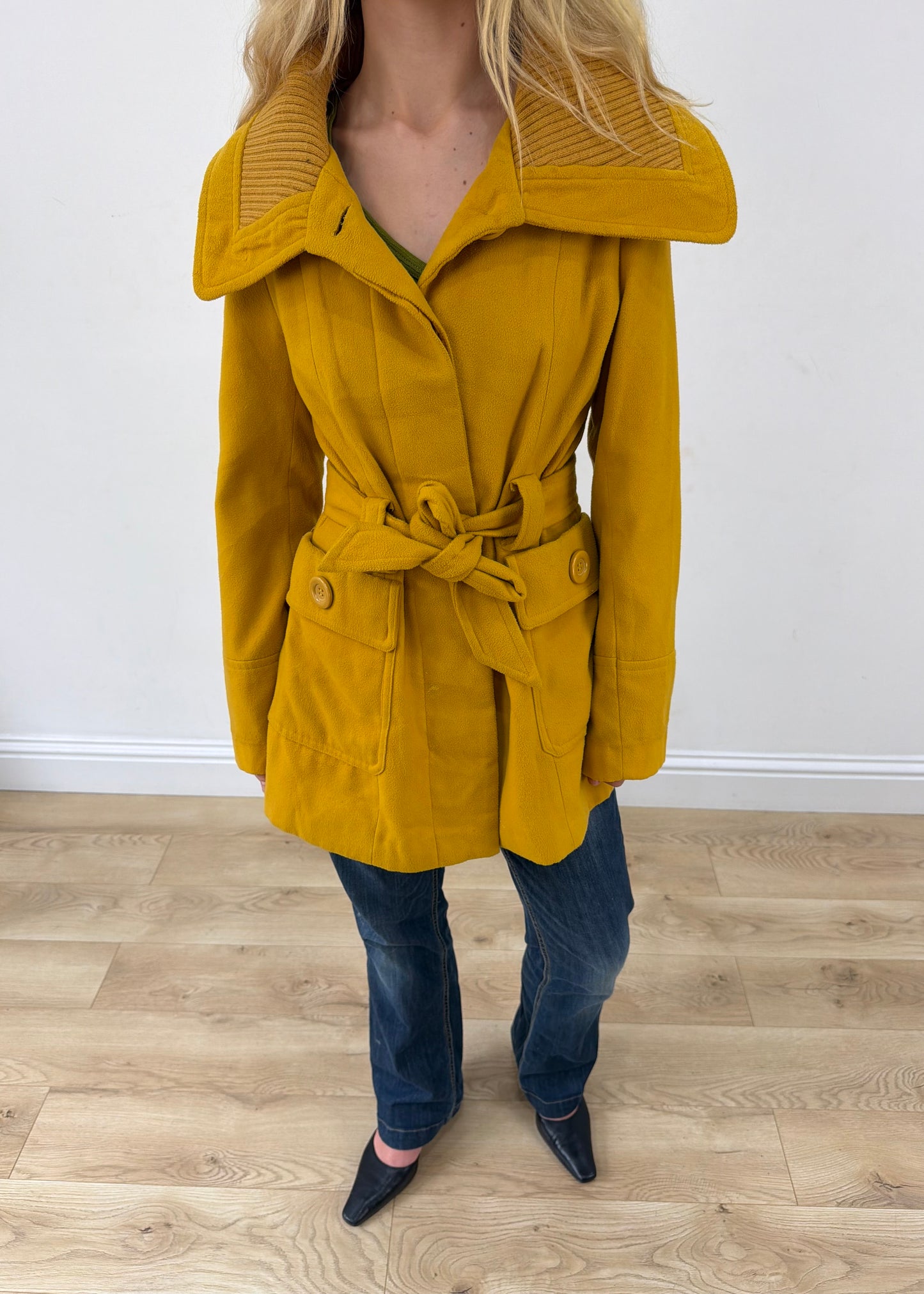 small yellow belted trench coat headless close-up