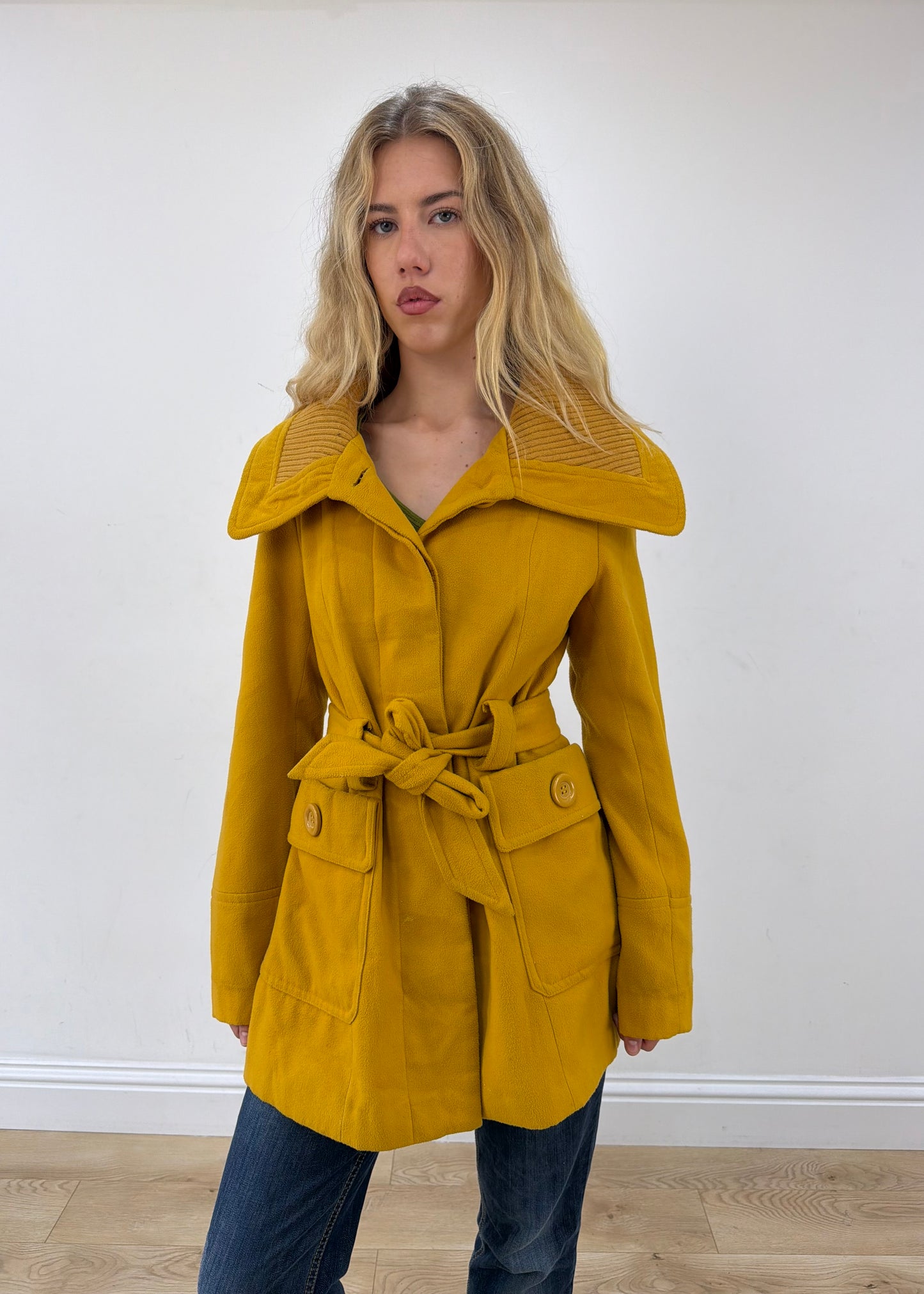 small yellow belted trench coat front close-up