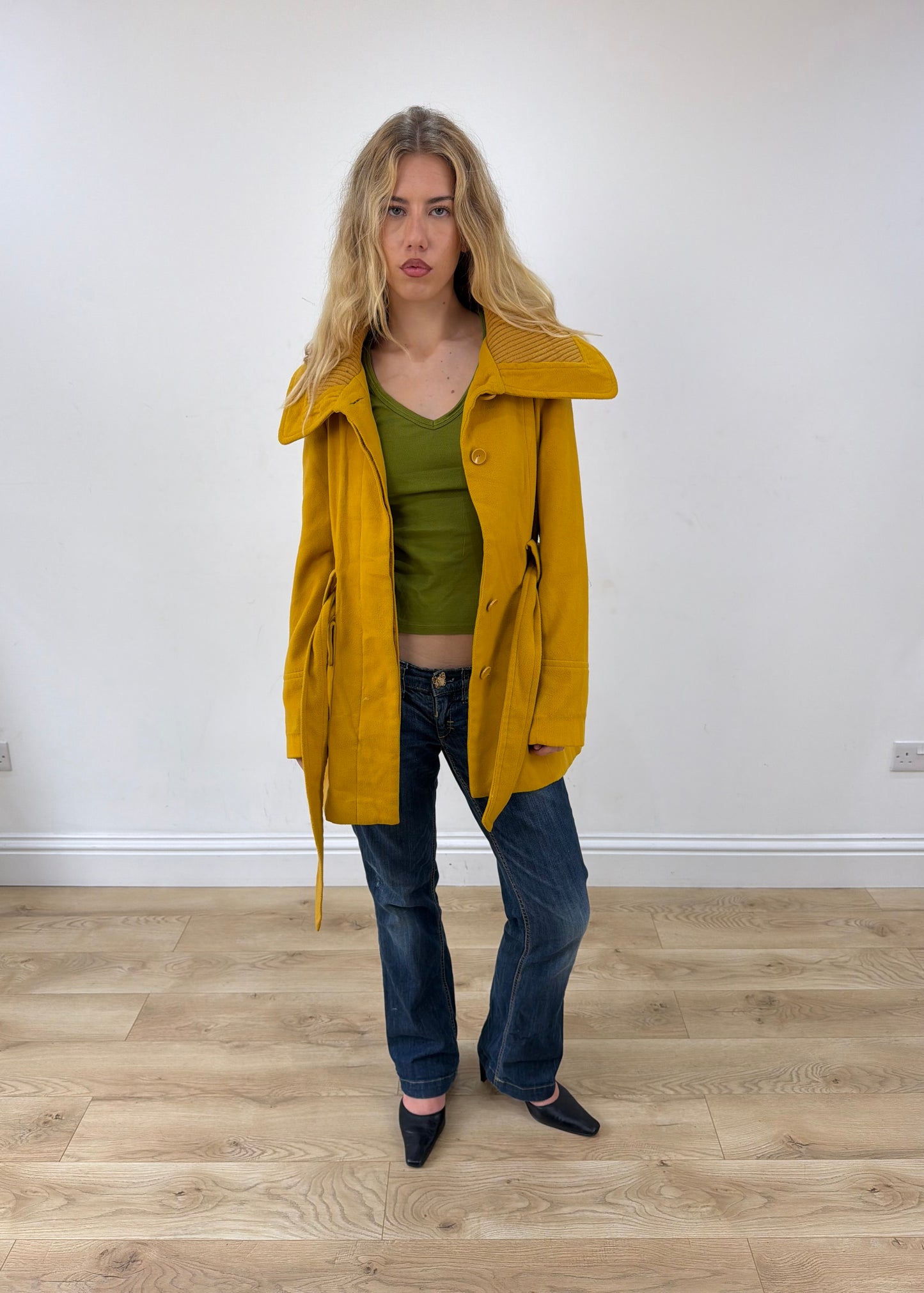 small yellow belted trench coat worn open