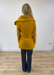 small yellow belted trench coat back view