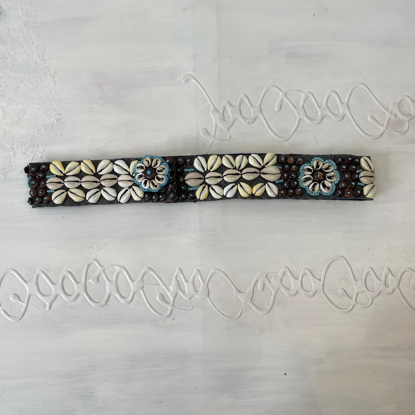 brown, blue and cream shell belt