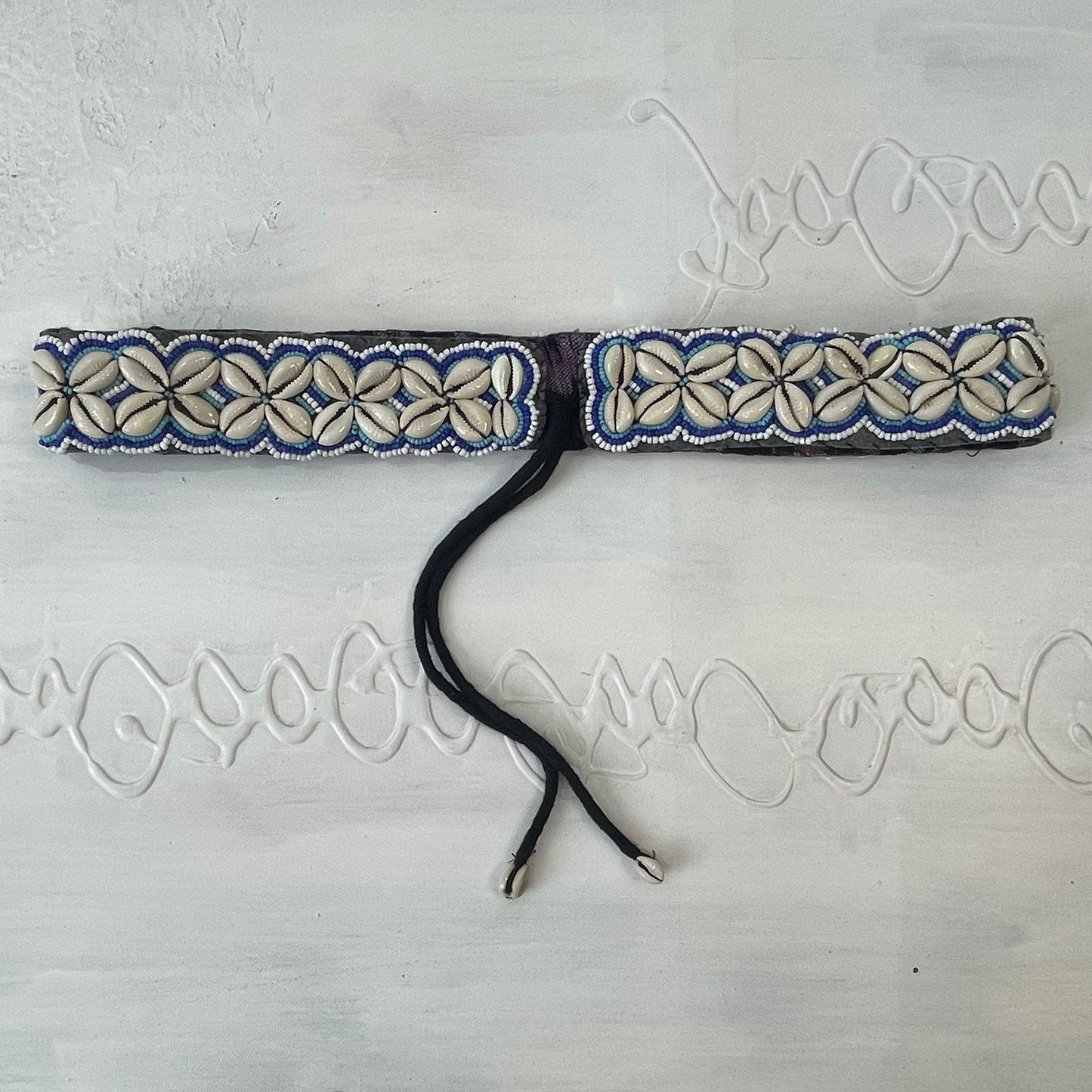 white and blue shell belt